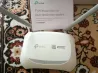 TP-Link TL-WR840N маршрутизаторы – жылдам баптау бойынша нұсқаулық жазылған, кілемнің фонында.